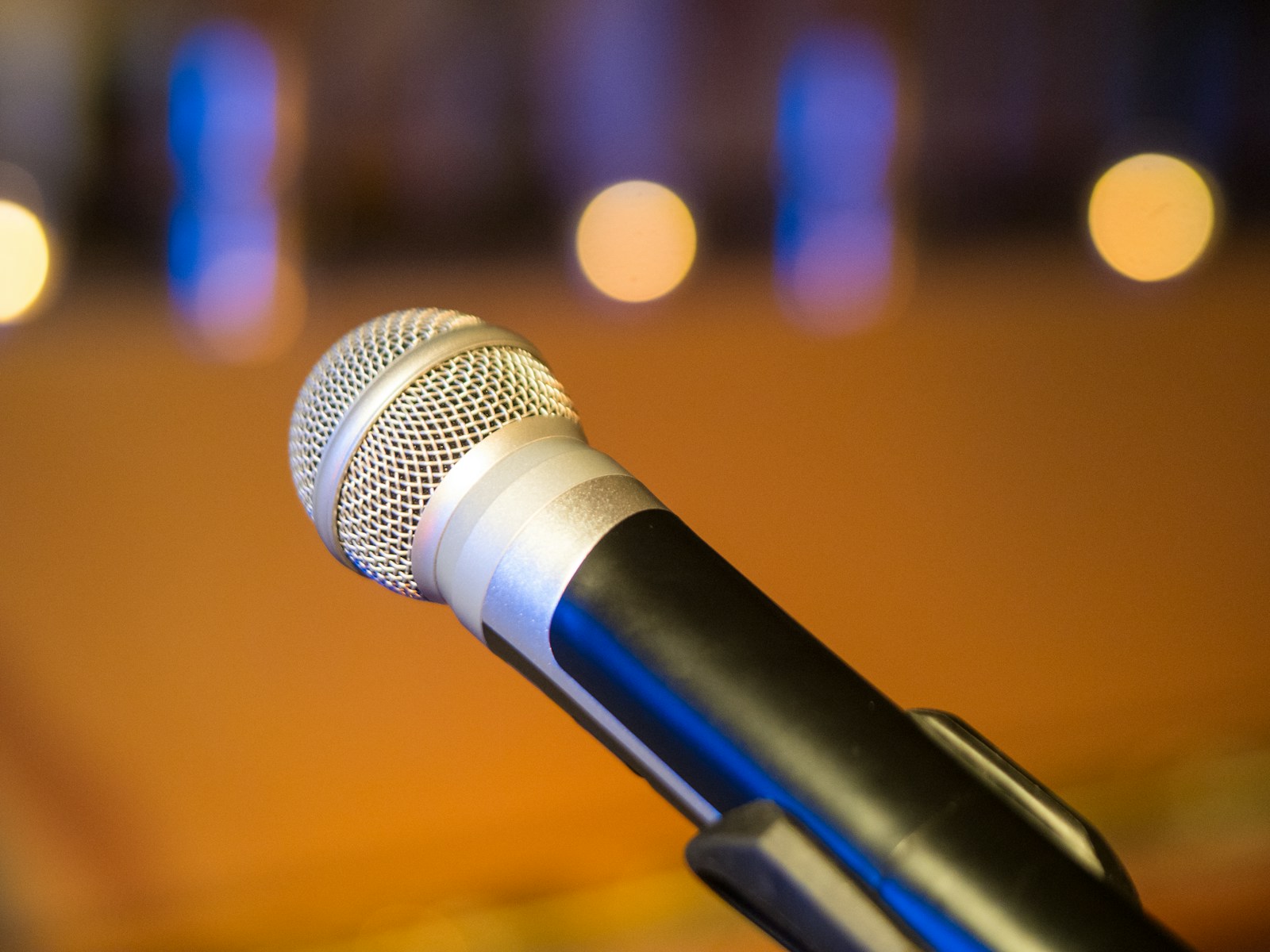 Hands clipping on a lavalier microphone